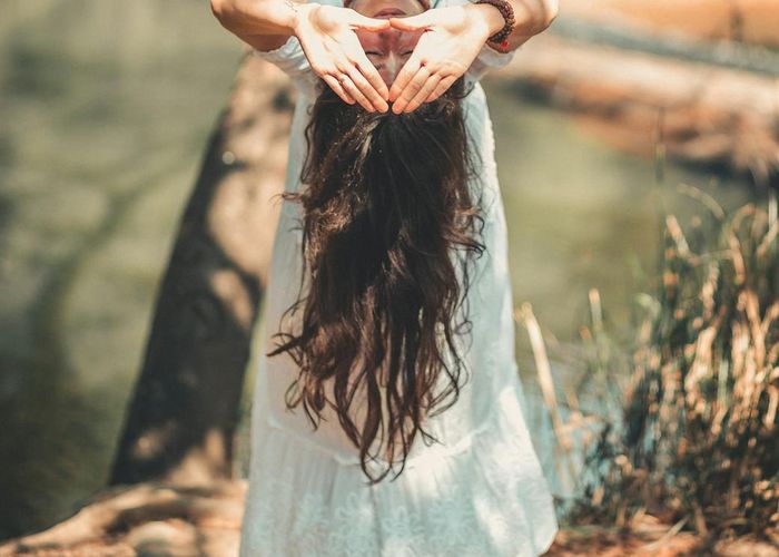 Person meditating peacefully in a serene environment.
